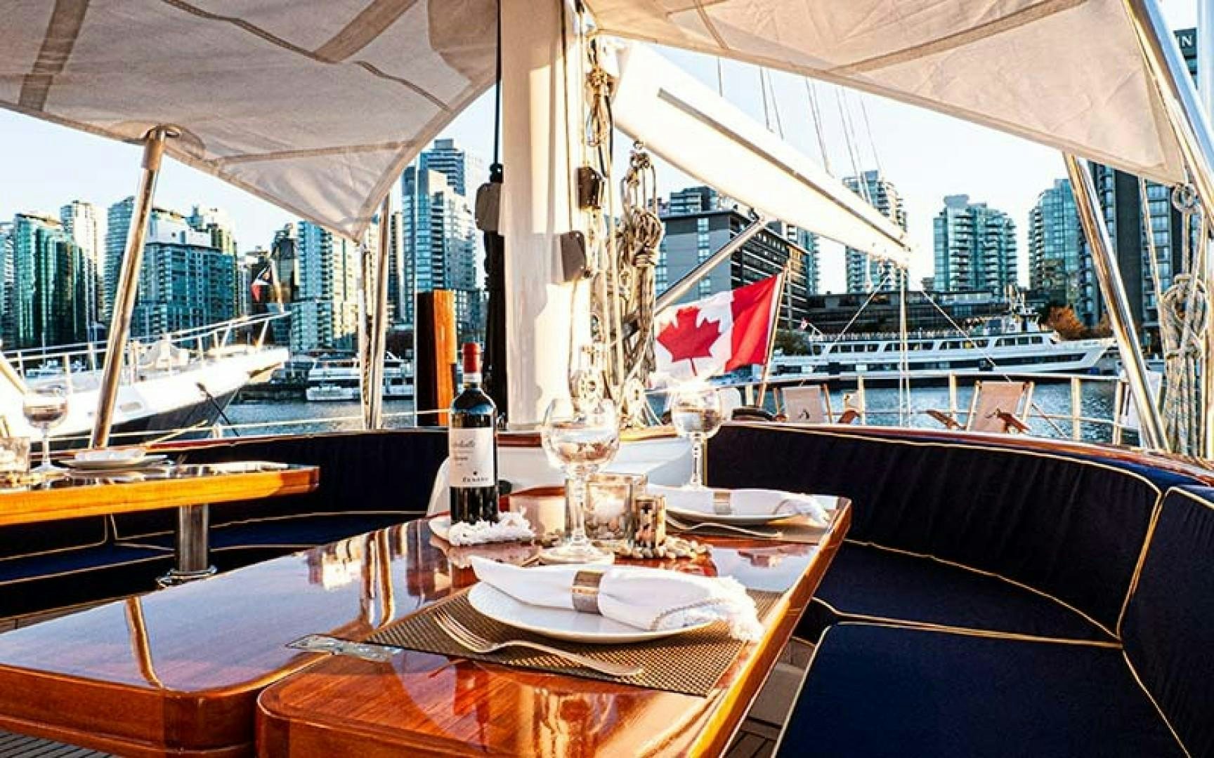 a table with a plate and glasses on it aboard AVALON Yacht for Sale