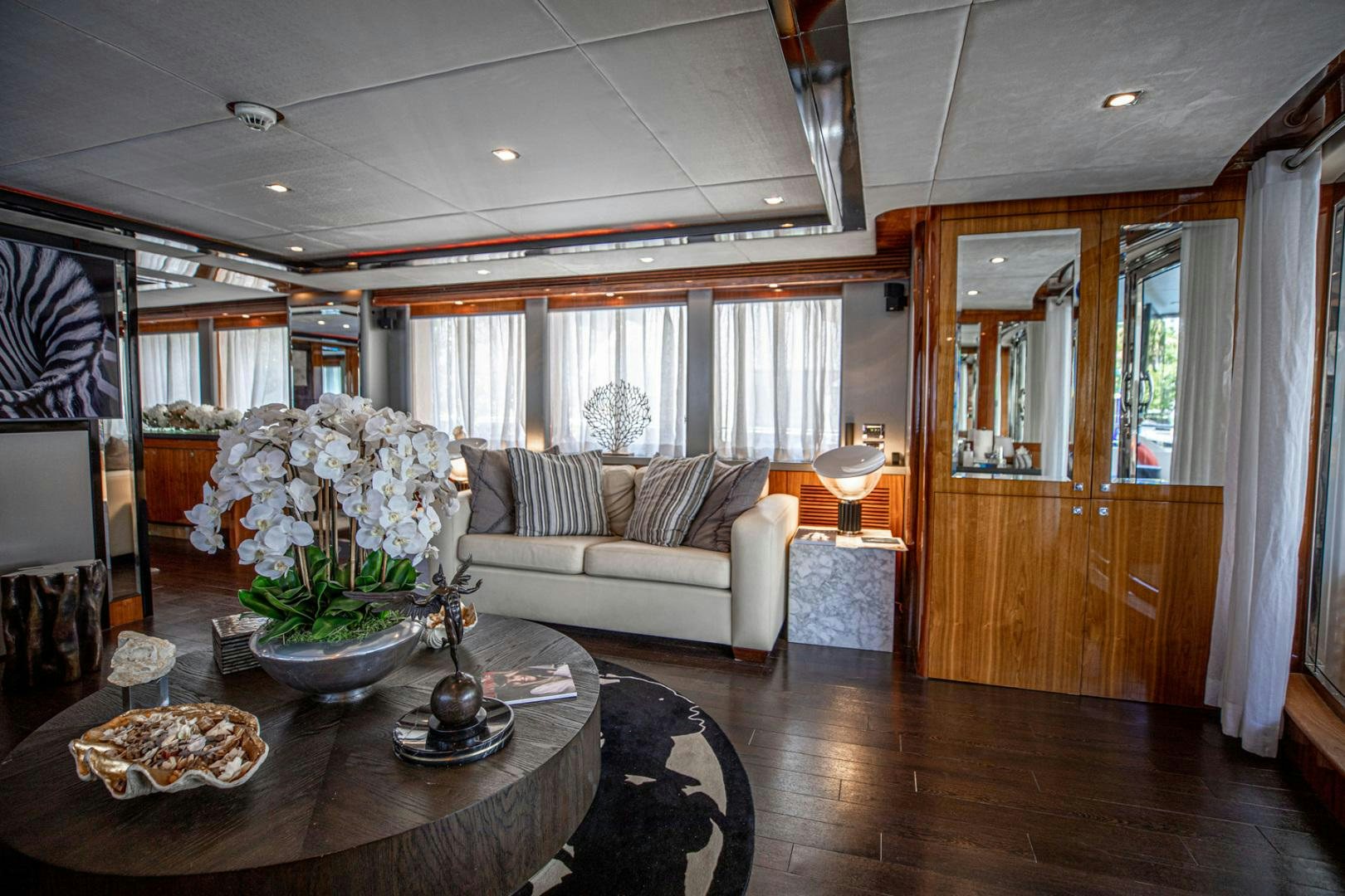 a living room with a couch and a table aboard LE SORELLE III Yacht for Sale