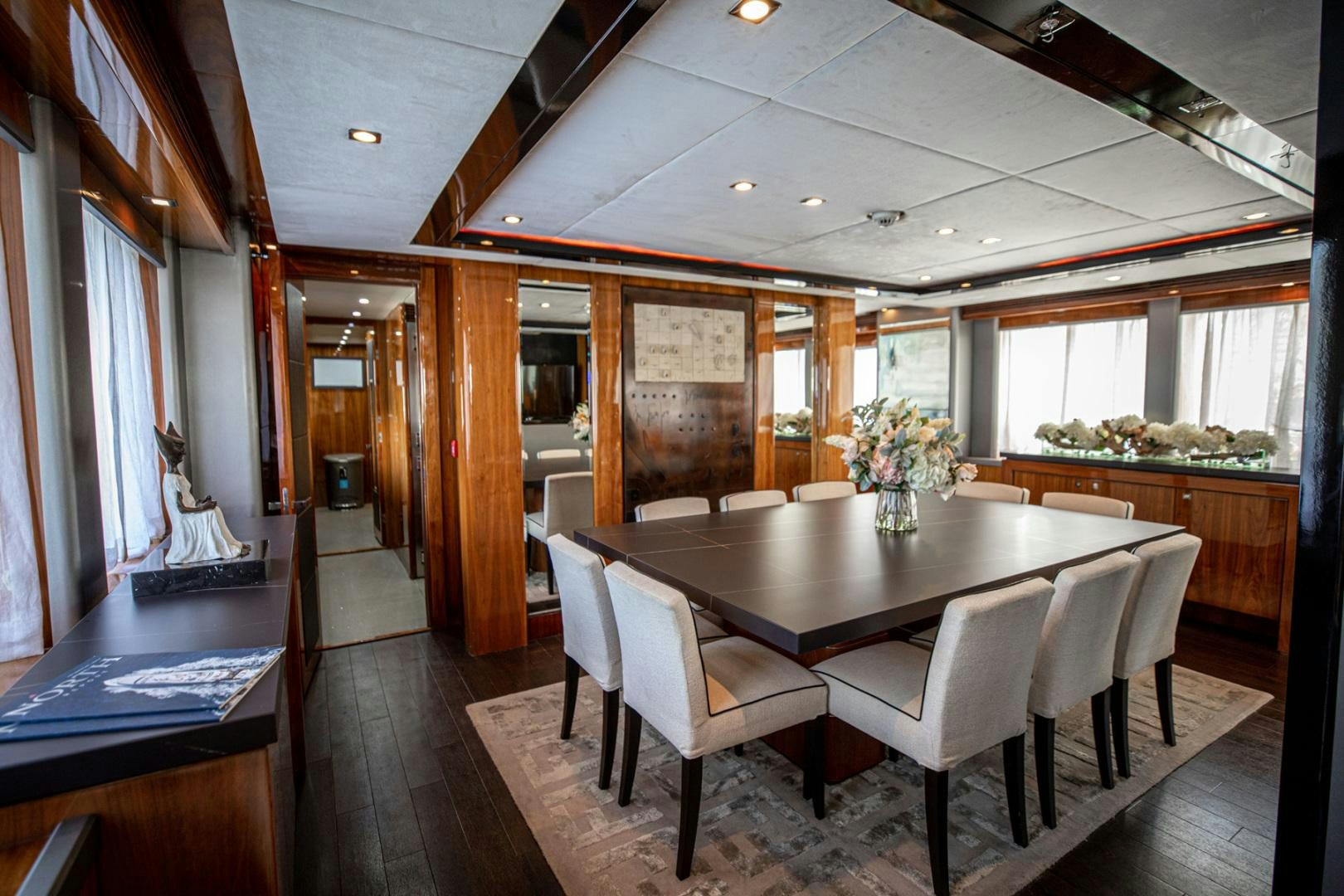 a large room with a table and chairs aboard LE SORELLE III Yacht for Sale