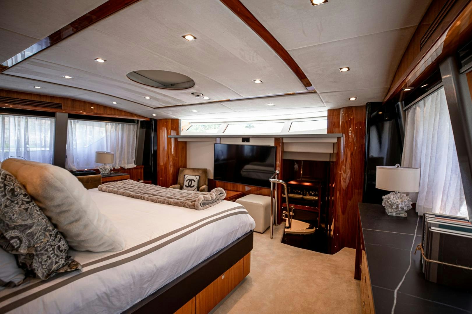 a bedroom with a bed and a desk aboard LE SORELLE III Yacht for Sale