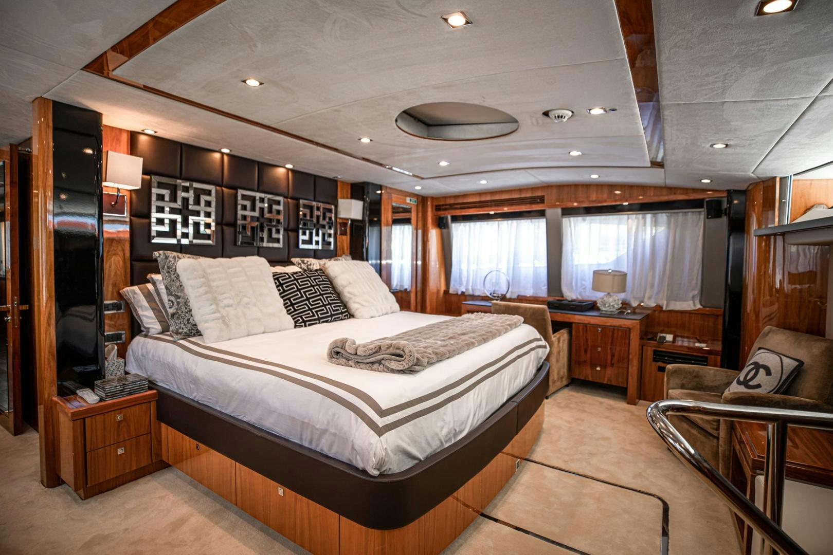 a bedroom with a bed and a couch aboard LE SORELLE III Yacht for Sale