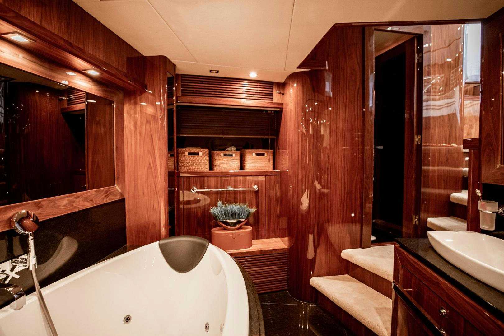 a bathroom with a tub sink and a wood door aboard LE SORELLE III Yacht for Sale