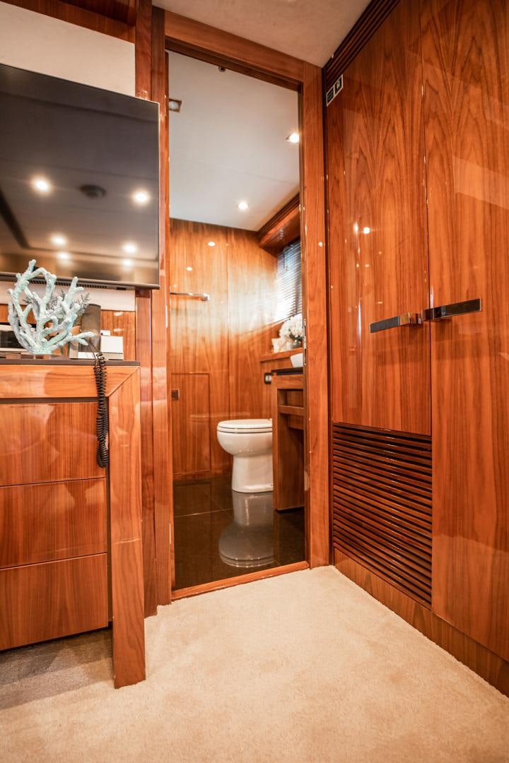 a bathroom with a wood door aboard LE SORELLE III Yacht for Sale