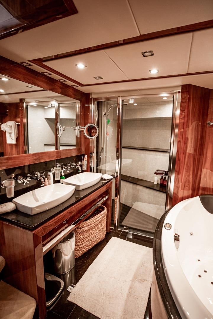 a bathroom with a sink and a bathtub aboard LE SORELLE III Yacht for Sale