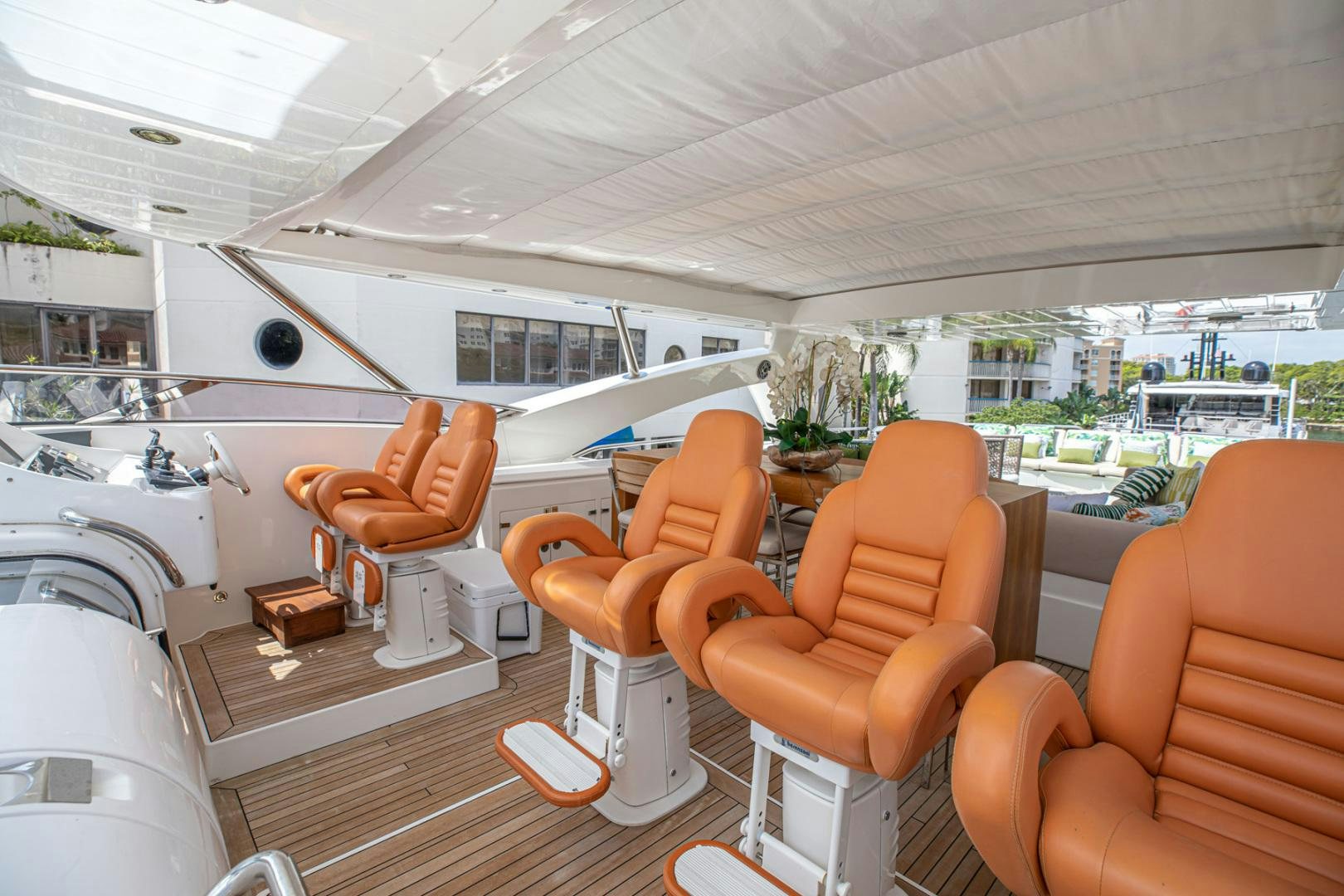 a room with a group of chairs and a table with a view of the city aboard LE SORELLE III Yacht for Sale