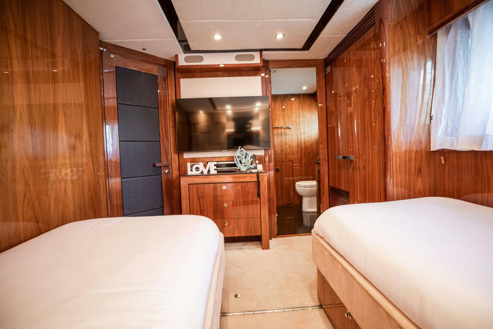 a room with a bed and a closet aboard LE SORELLE III Yacht for Sale
