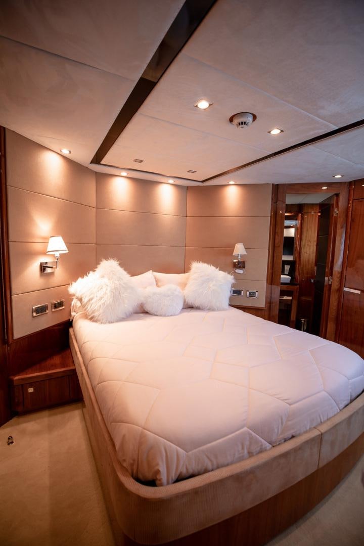 a bed with white sheets aboard LE SORELLE III Yacht for Sale