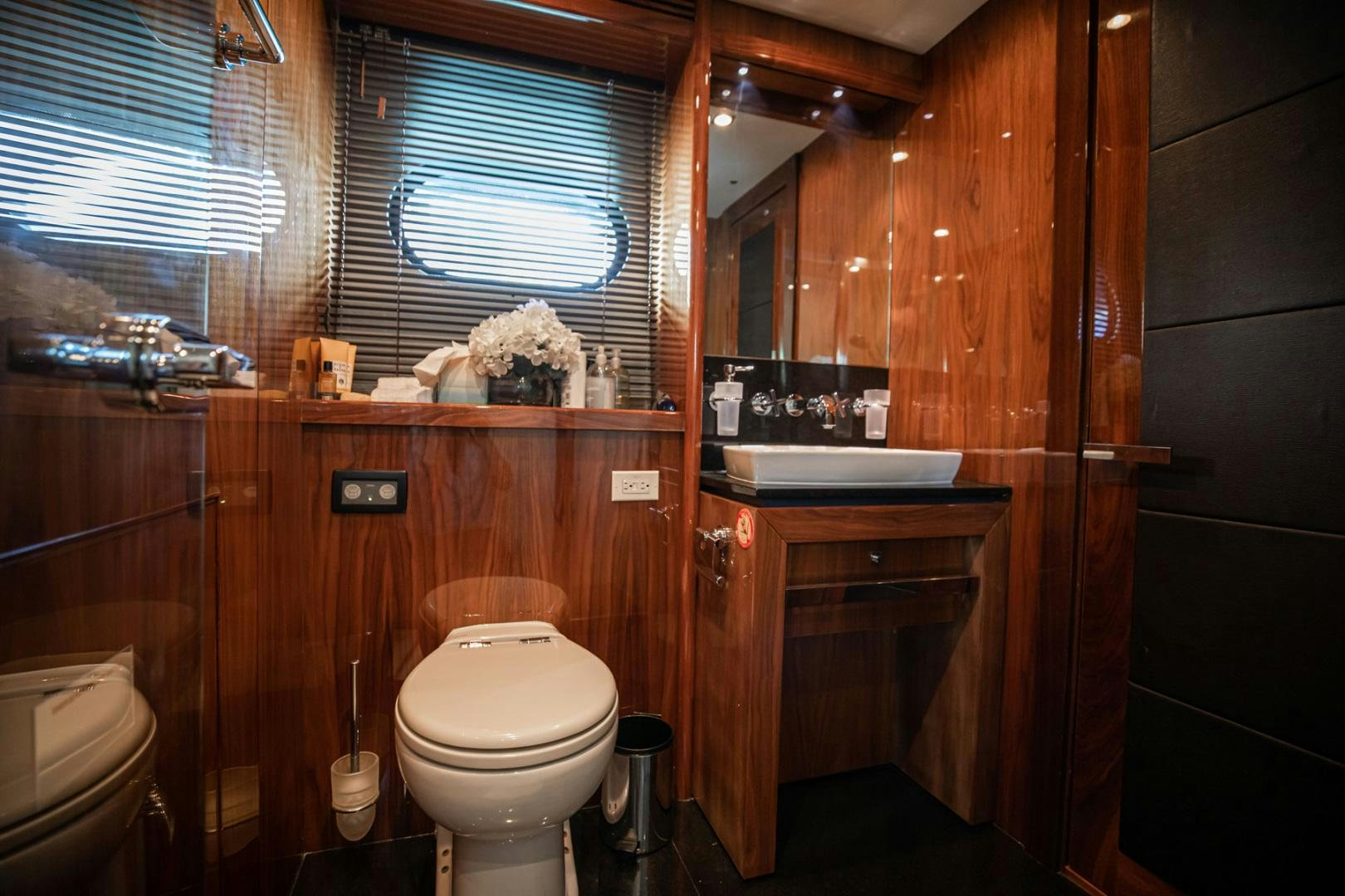 a bathroom with a toilet and a sink aboard LE SORELLE III Yacht for Sale