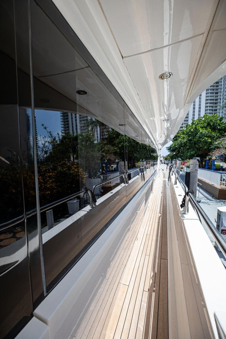 a long white boat on a dock aboard LE SORELLE III Yacht for Sale