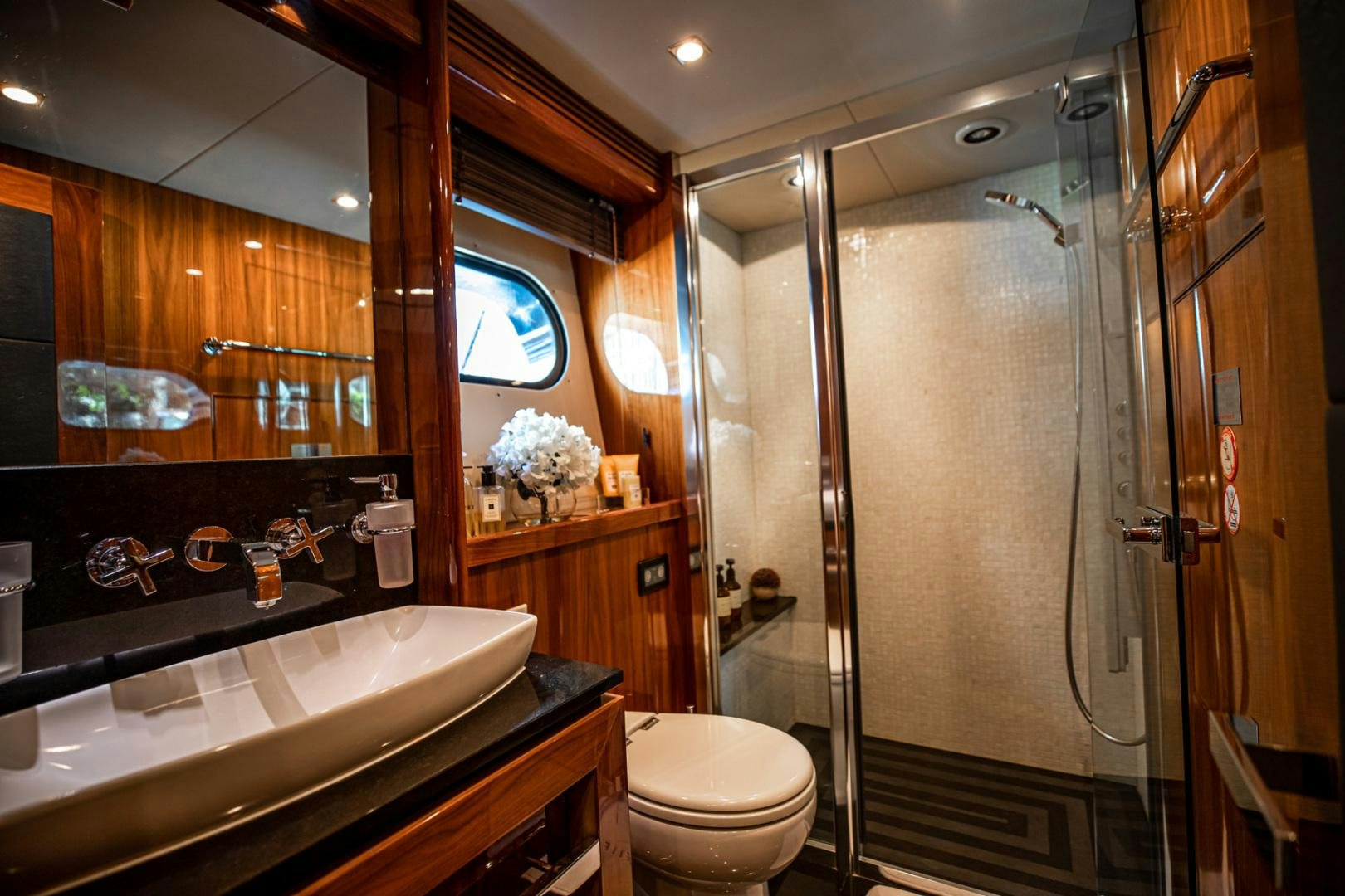 a bathroom with a glass shower aboard LE SORELLE III Yacht for Sale