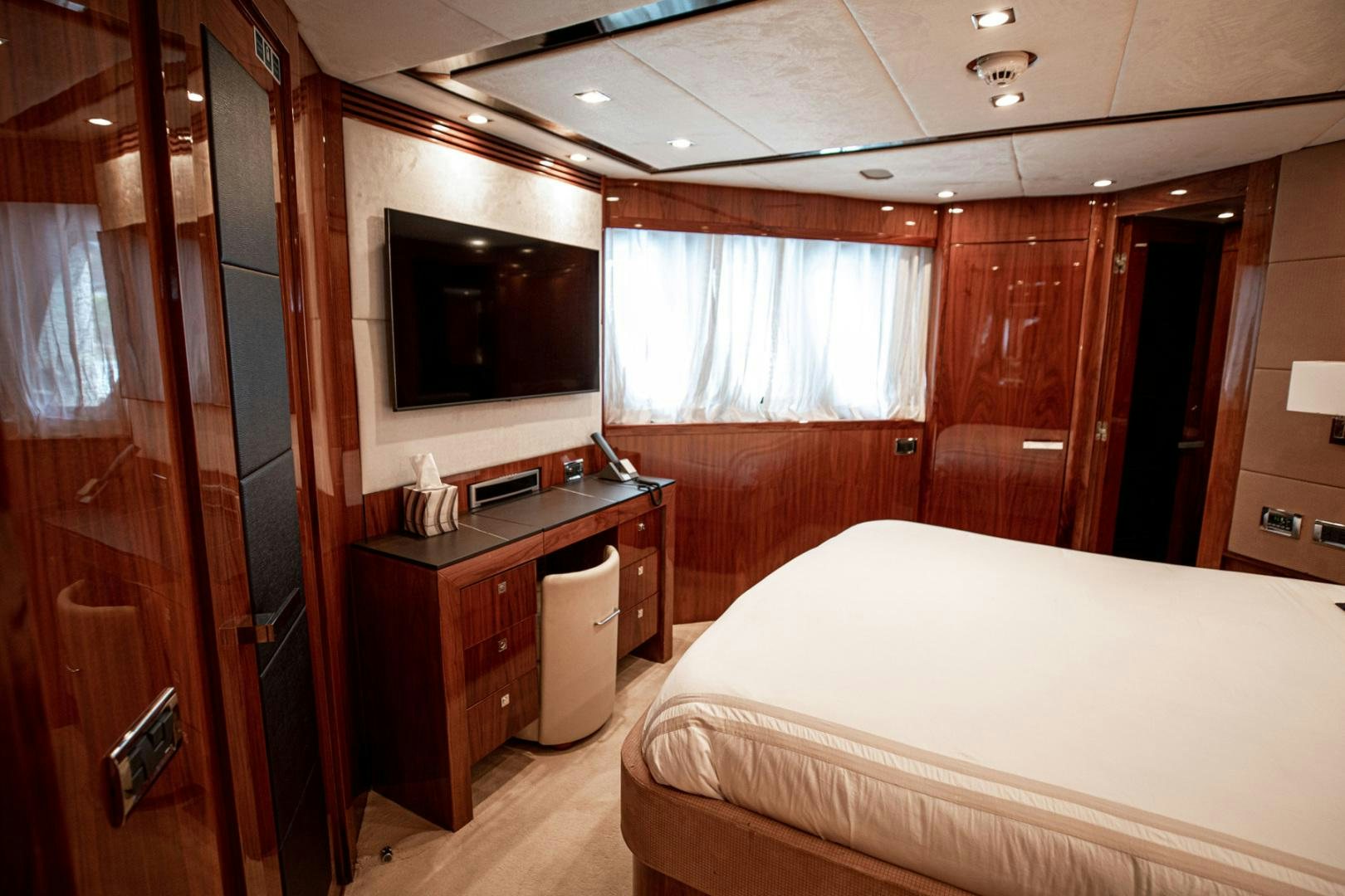 a bedroom with a bed and a closet aboard LE SORELLE III Yacht for Sale