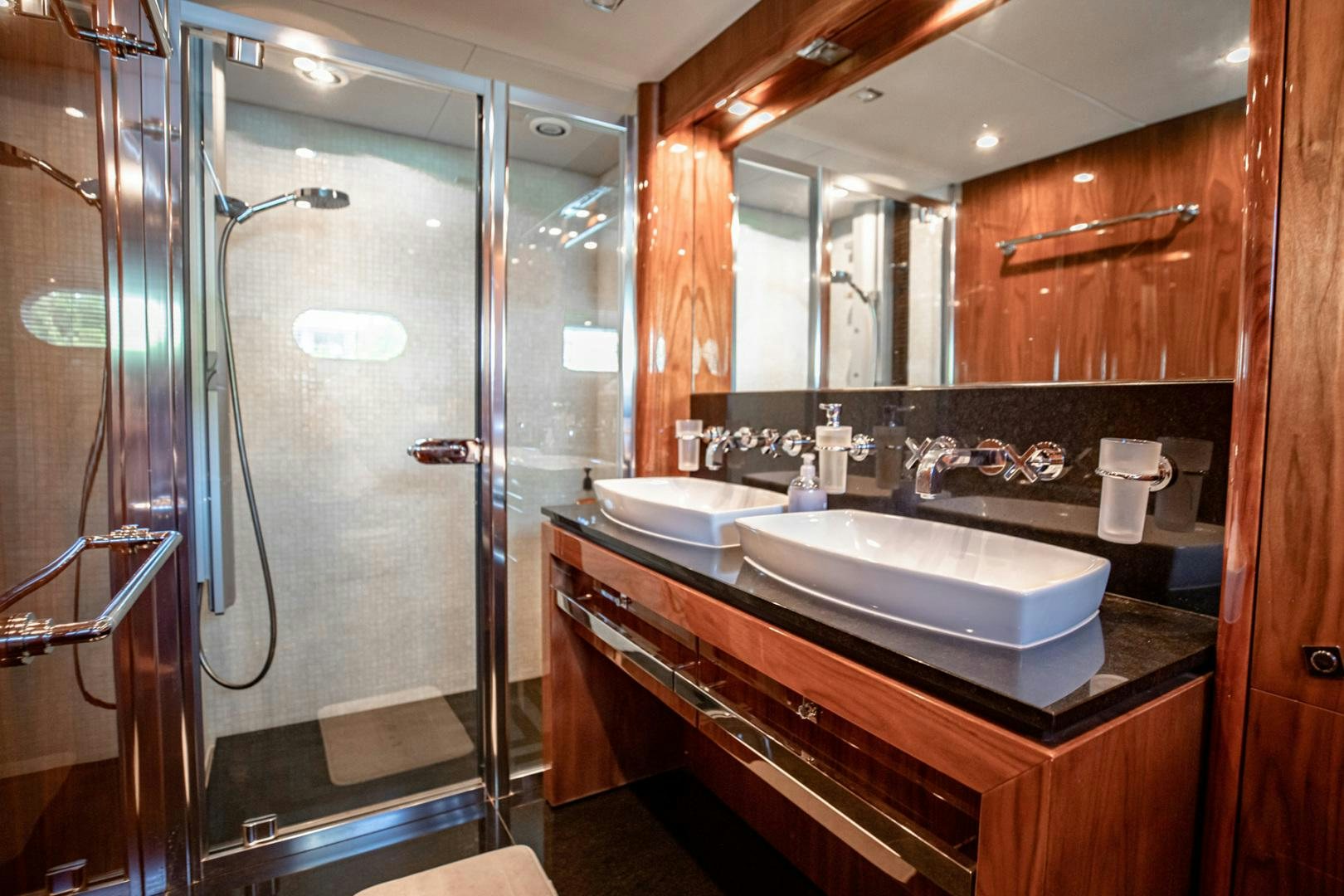 a bathroom with a glass shower aboard LE SORELLE III Yacht for Sale