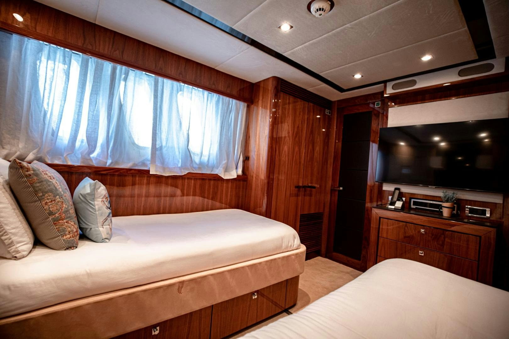a bedroom with a bed and a television aboard LE SORELLE III Yacht for Sale