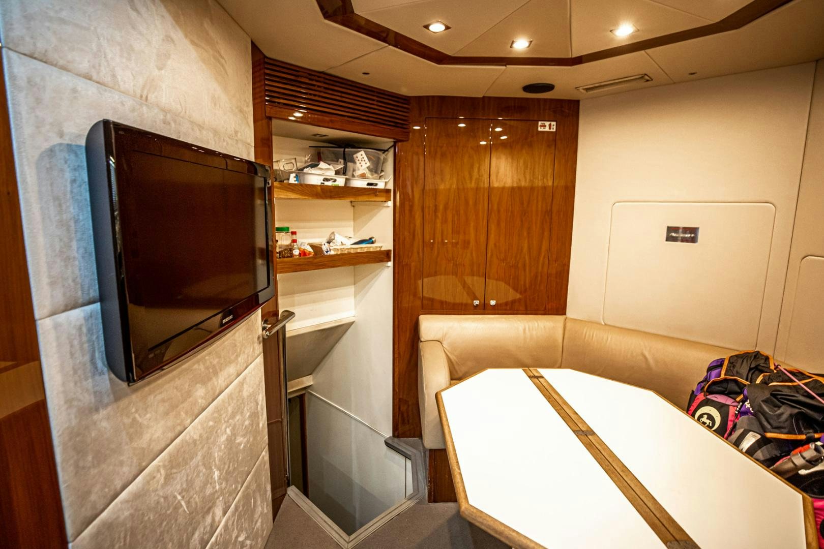 a room with a tv and a bed aboard LE SORELLE III Yacht for Sale