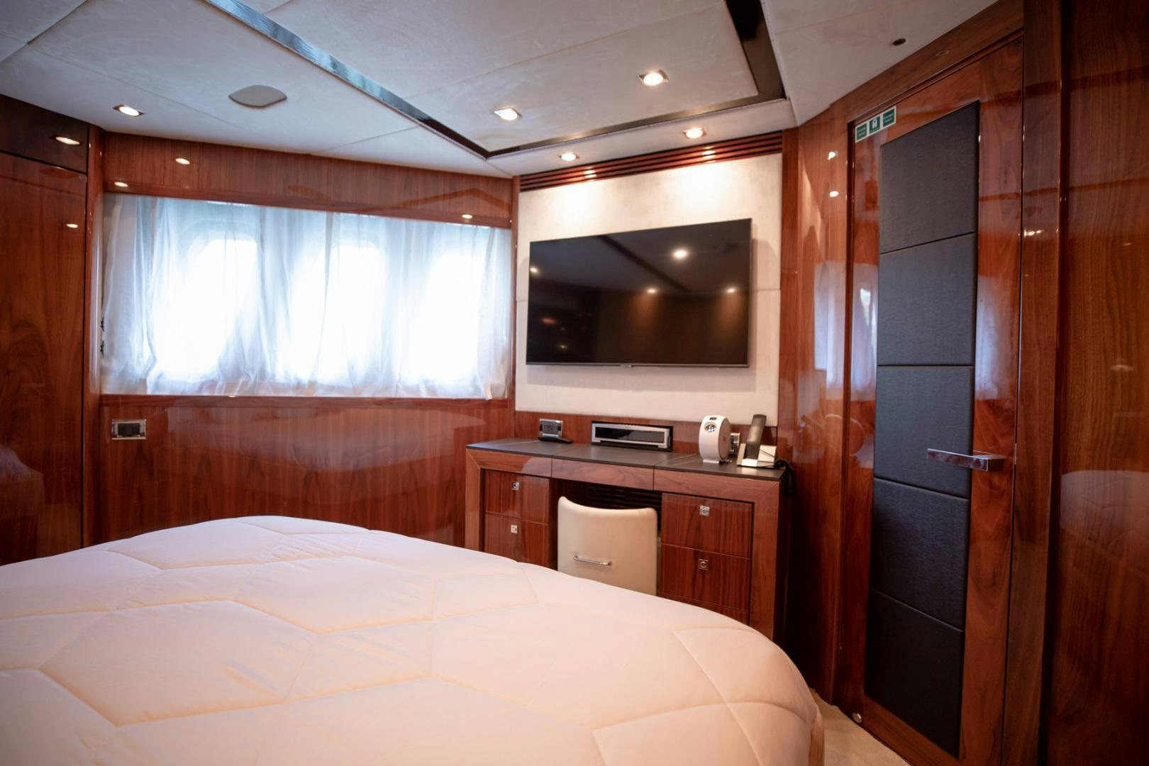 a bedroom with a bed and a television aboard LE SORELLE III Yacht for Sale