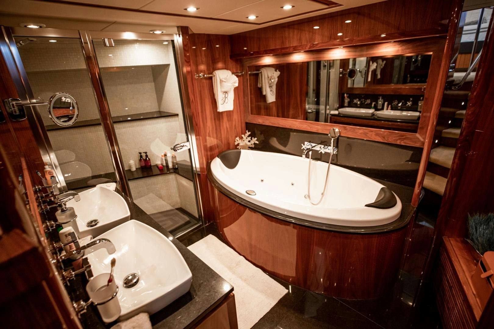a bathroom with a bathtub and sink aboard LE SORELLE III Yacht for Sale