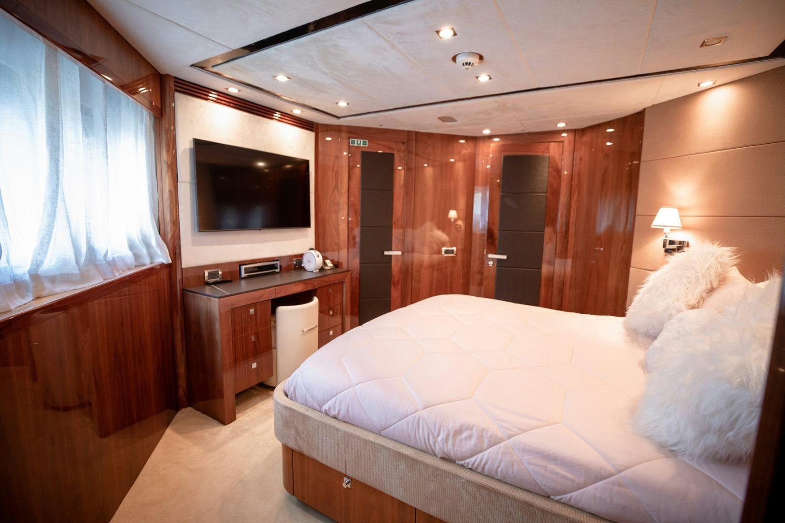 a bedroom with a bed and a television aboard LE SORELLE III Yacht for Sale