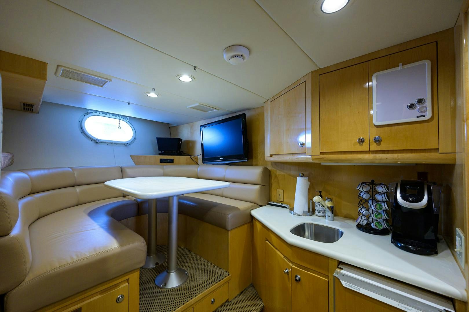 a kitchen with a couch and a television aboard MEMORYMAKER Yacht for Sale