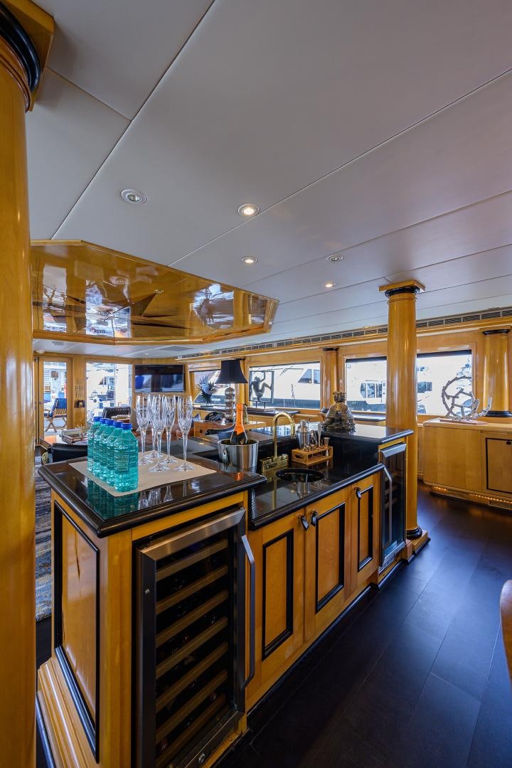 a kitchen with a bar and cabinets aboard MEMORYMAKER Yacht for Sale