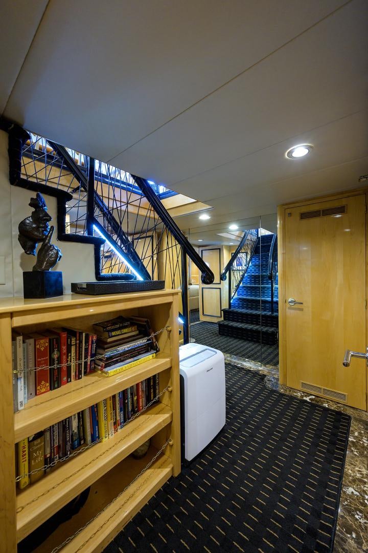 a room with shelves and a book shelf aboard MEMORYMAKER Yacht for Sale