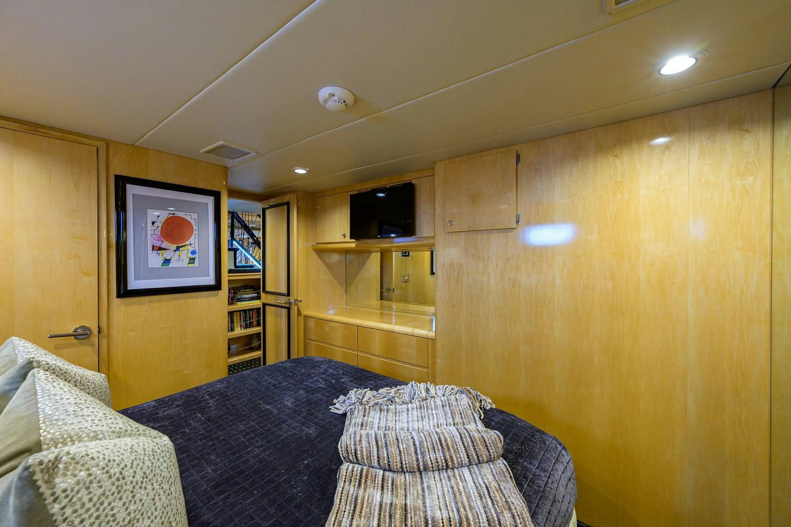 a bedroom with a bed and a television aboard MEMORYMAKER Yacht for Sale