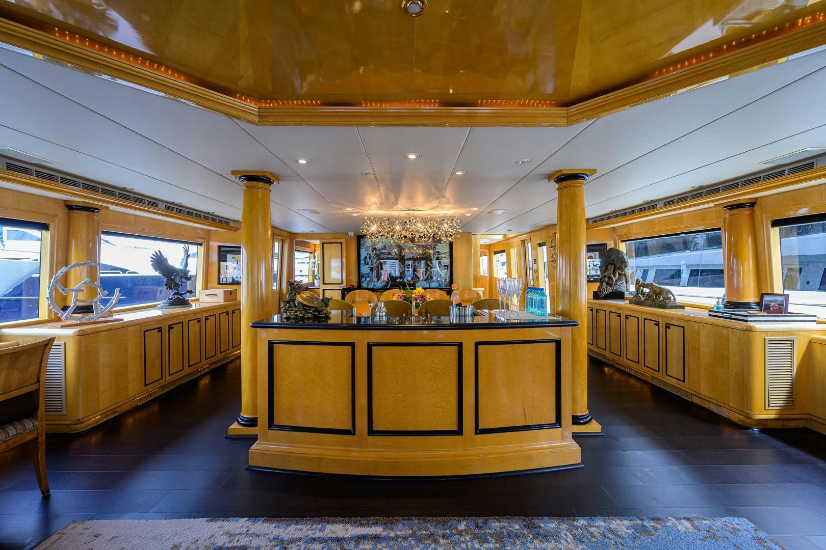 a large room with a bar and a table aboard MEMORYMAKER Yacht for Sale
