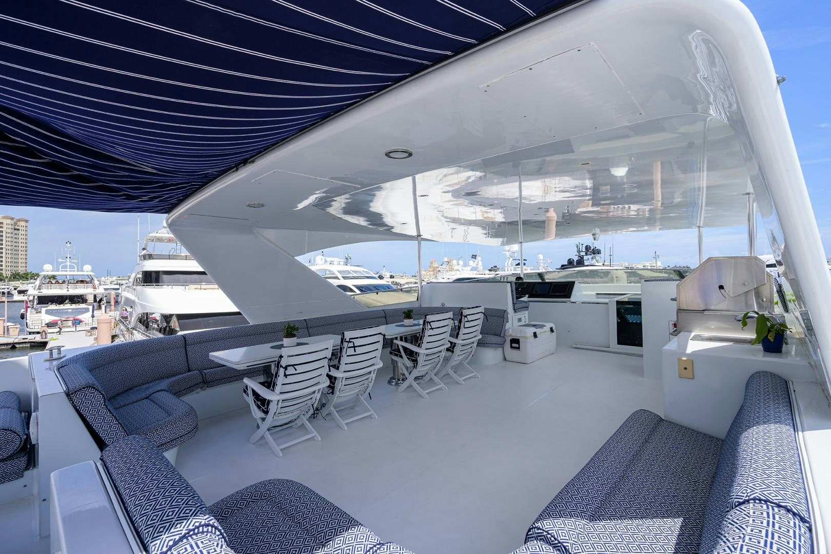 a large white tent with chairs and a table and a view of the city aboard MEMORYMAKER Yacht for Sale