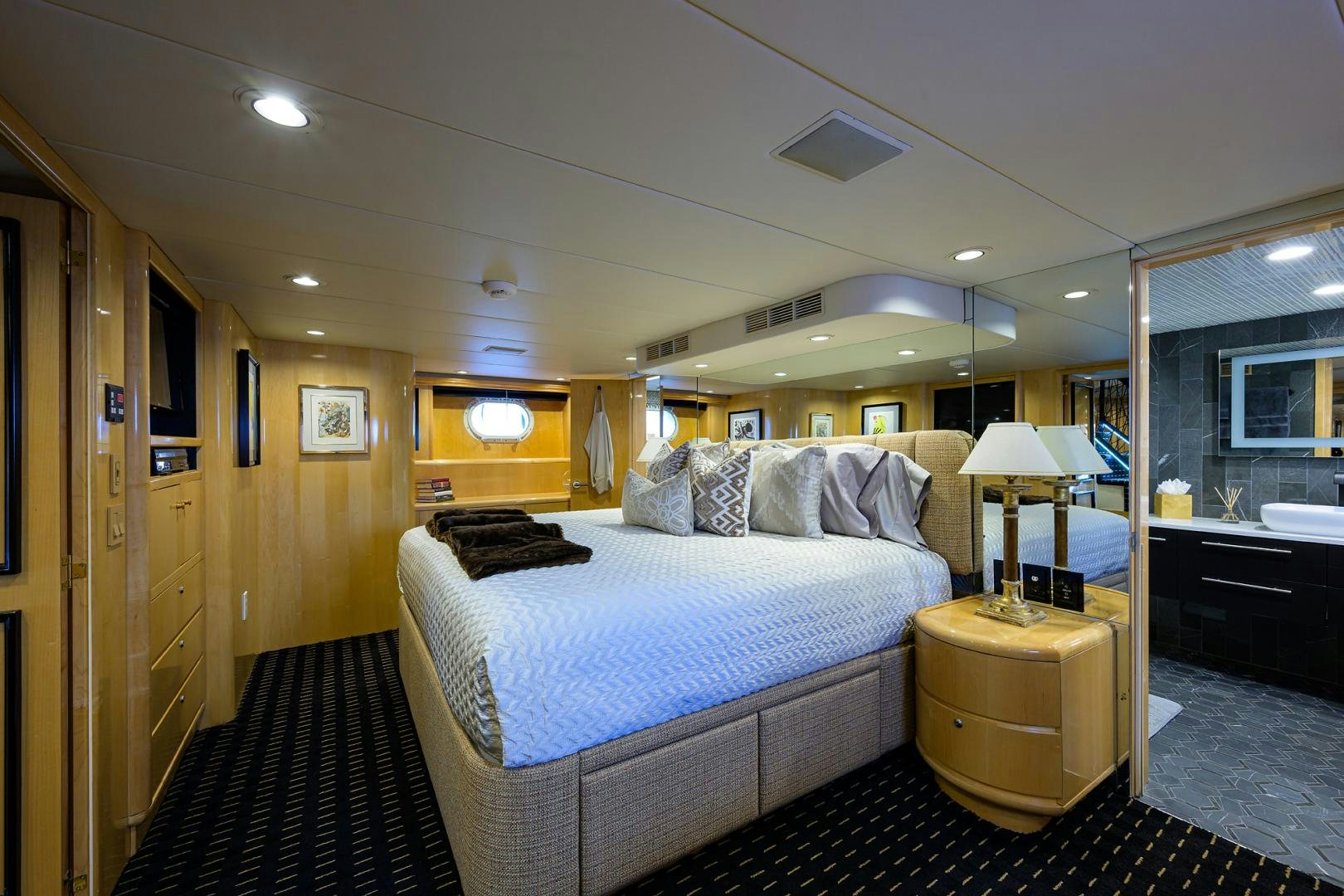 a bedroom with a bed and a desk aboard MEMORYMAKER Yacht for Sale