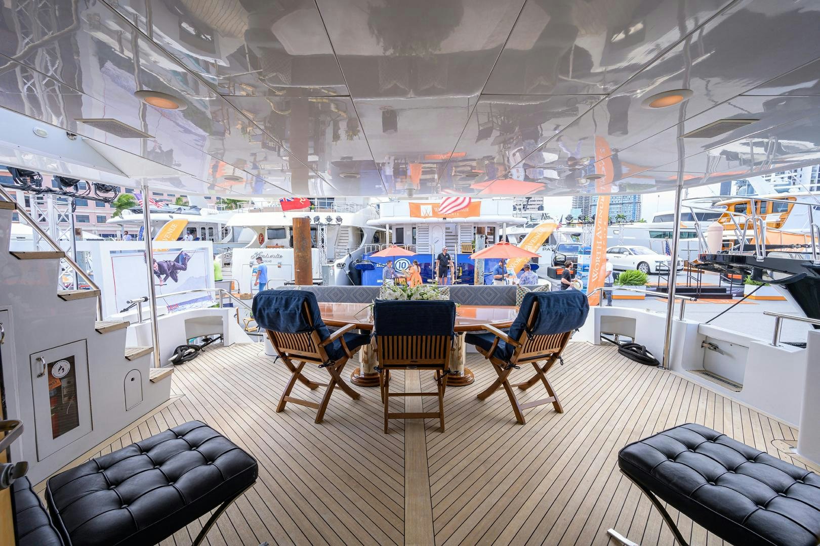 a room with a table chairs and a couch aboard MEMORYMAKER Yacht for Sale