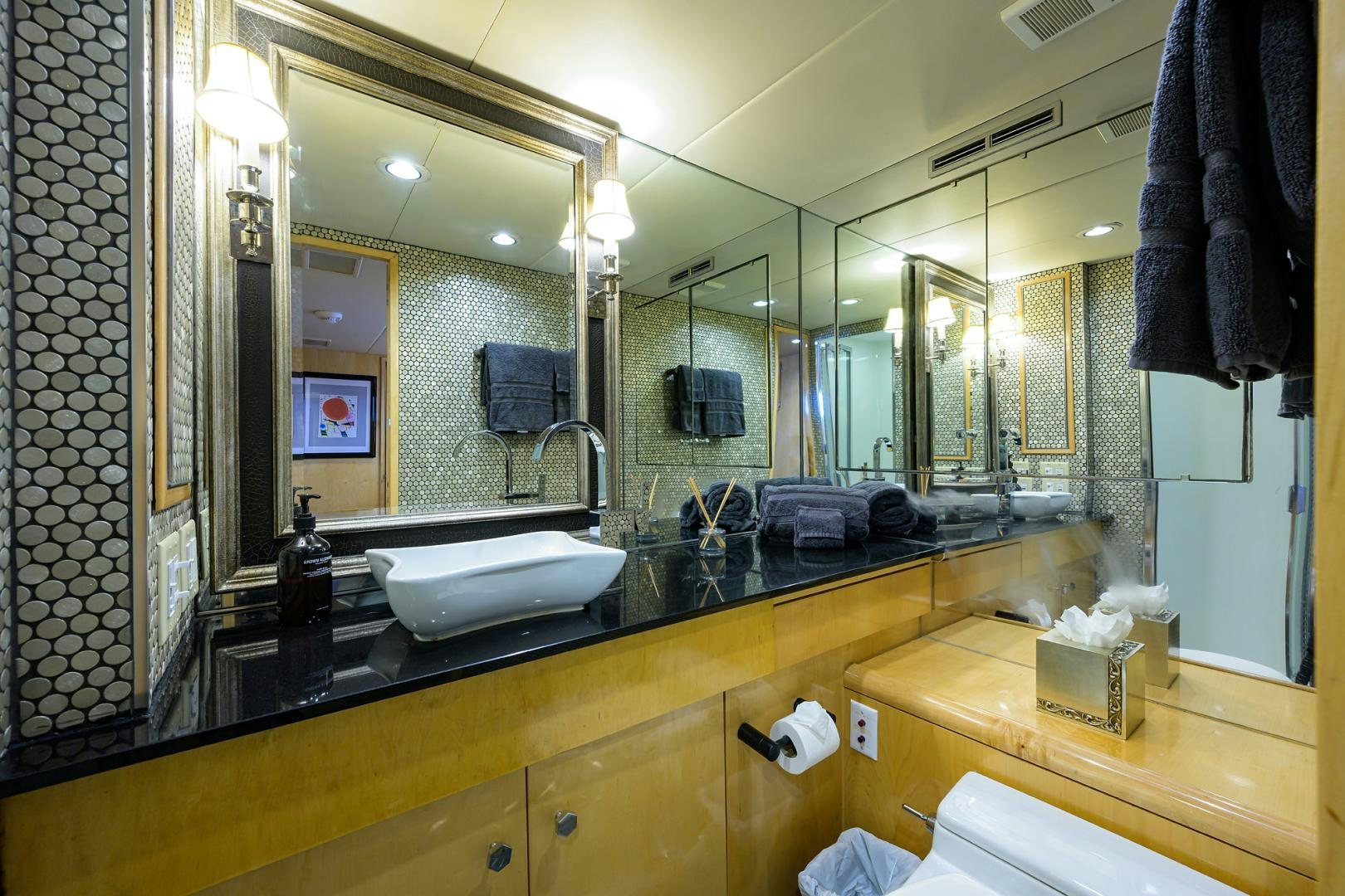 a bathroom with a large mirror aboard MEMORYMAKER Yacht for Sale