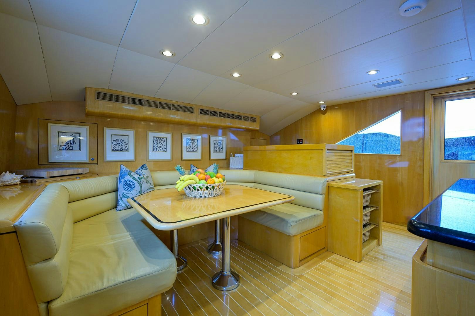 a room with a table and couches aboard MEMORYMAKER Yacht for Sale