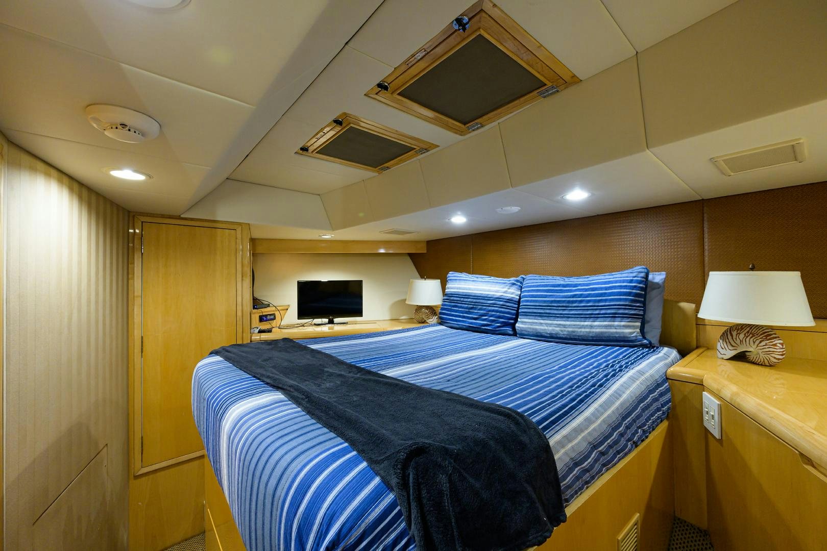 a bedroom with a bed and a desk aboard MEMORYMAKER Yacht for Sale
