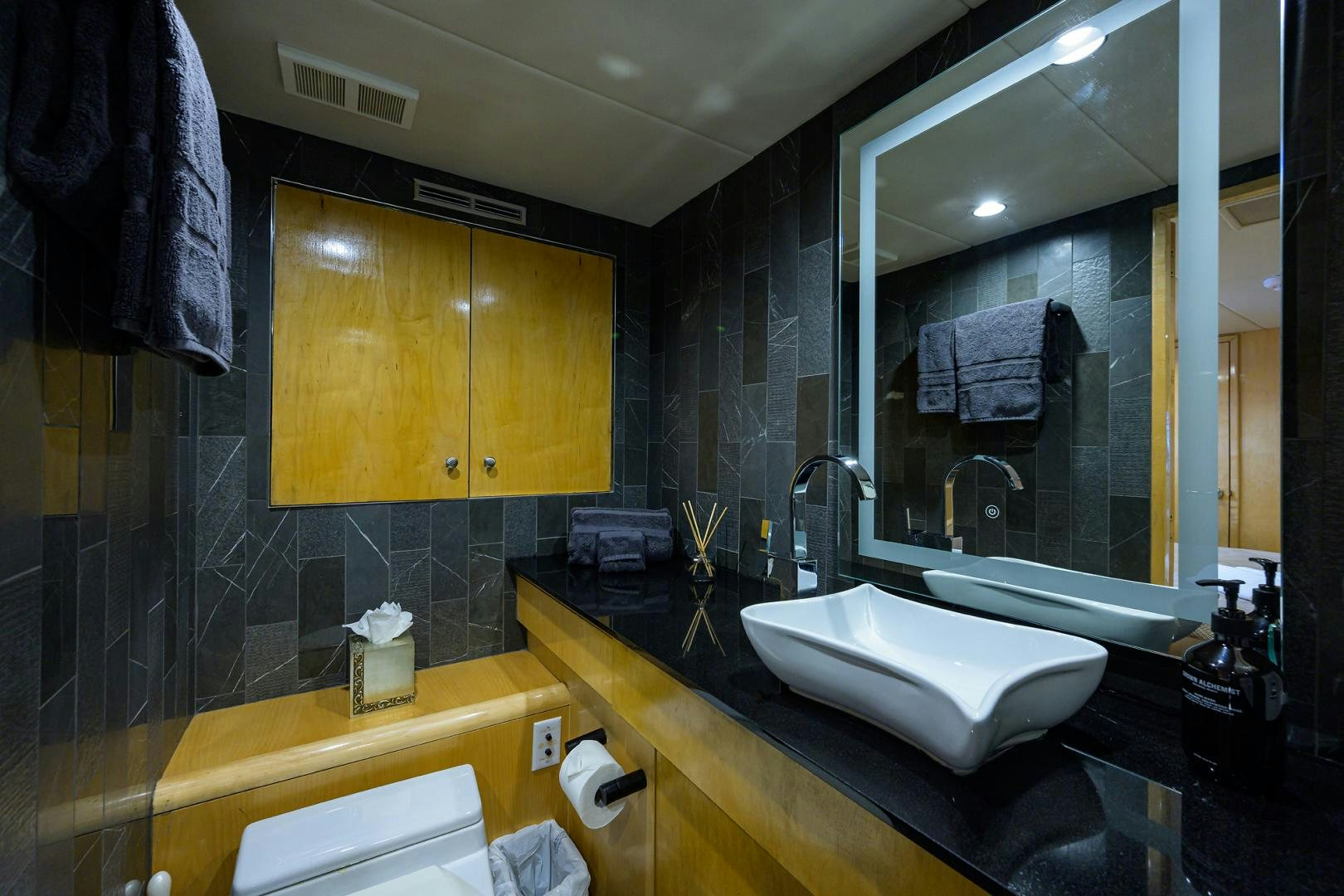 a bathroom with a large mirror aboard MEMORYMAKER Yacht for Sale