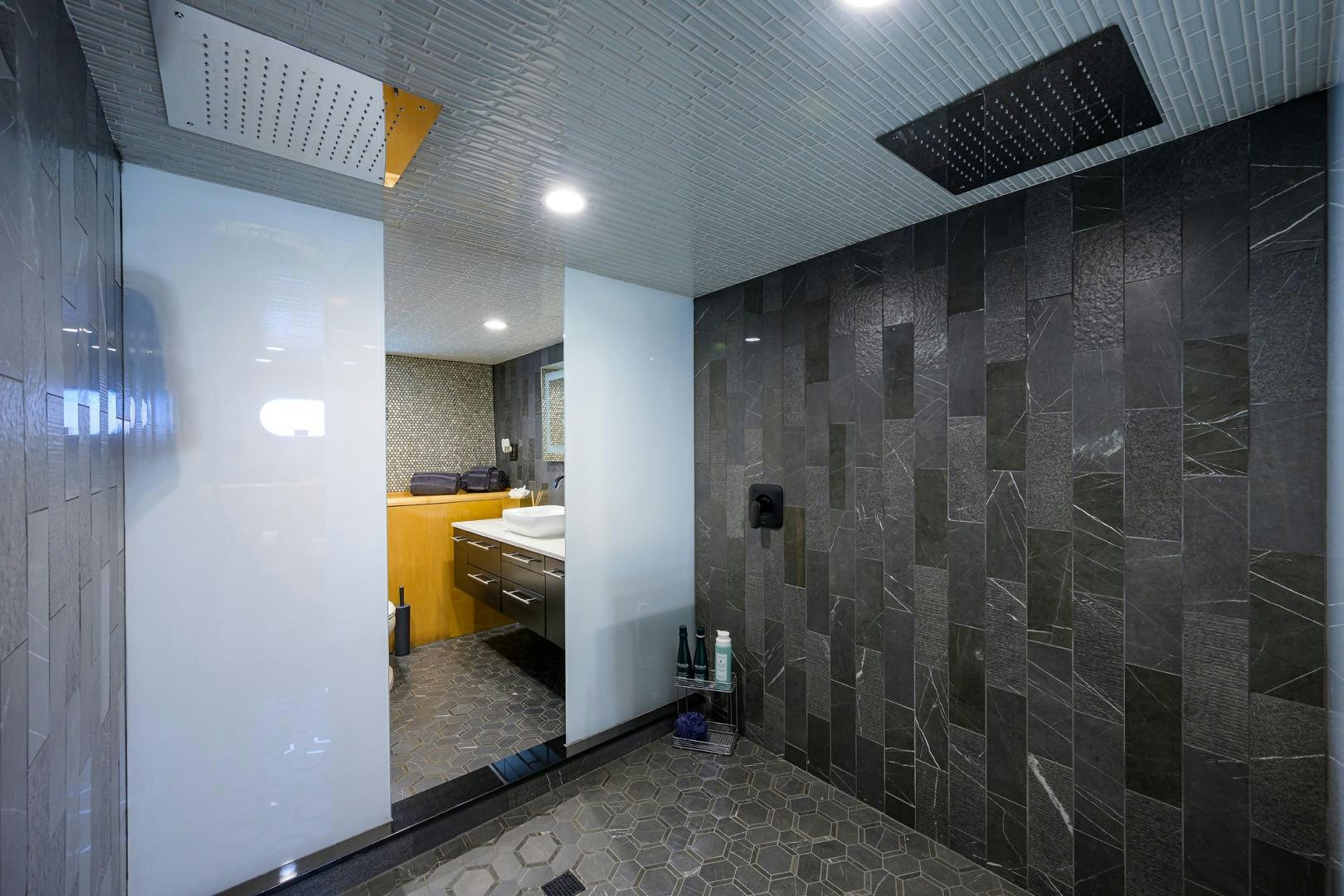 a bathroom with a tile wall aboard MEMORYMAKER Yacht for Sale