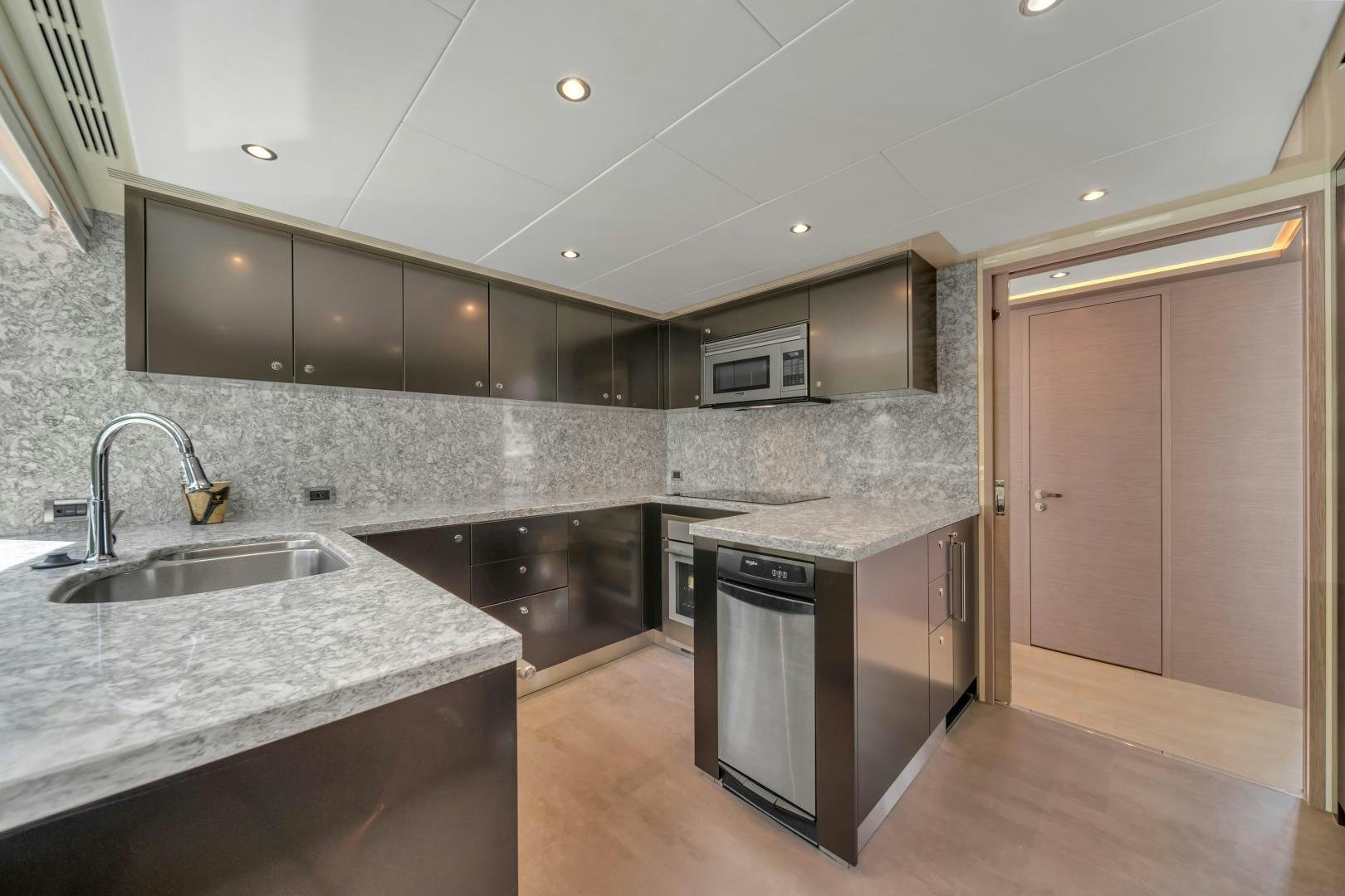 a kitchen with a black stove aboard CARBON COPY Yacht for Sale