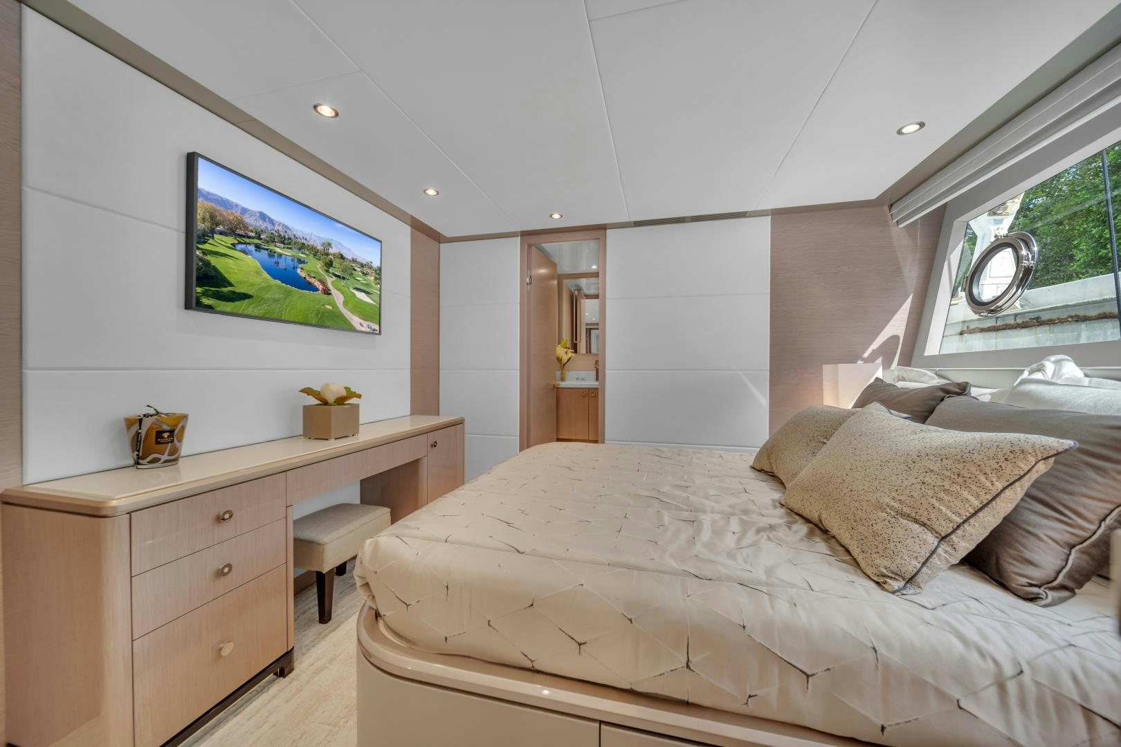 a bedroom with a bed and a desk aboard CARBON COPY Yacht for Sale