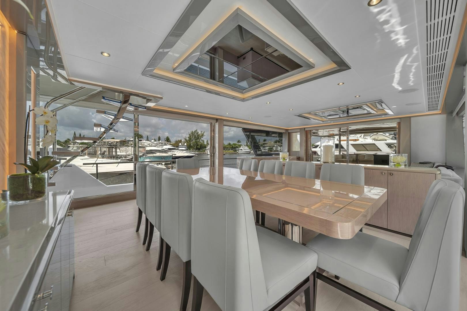 a room with a table chairs and a large window aboard CARBON COPY Yacht for Sale