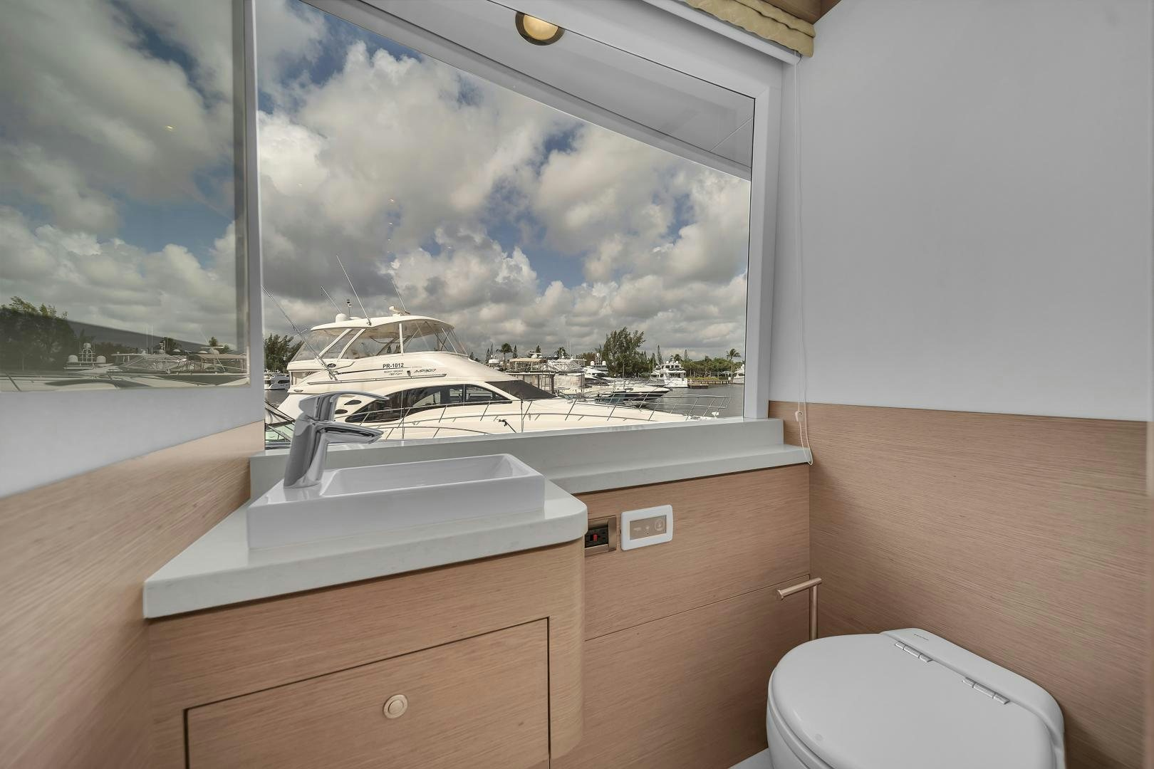 a bathroom with a large window aboard CARBON COPY Yacht for Sale