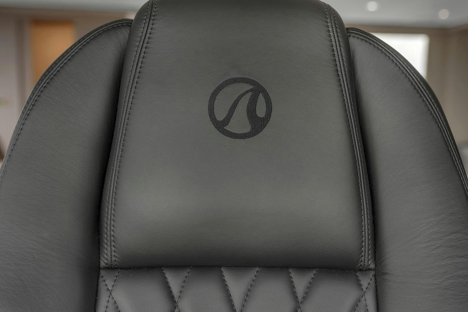 a black leather chair aboard CARBON COPY Yacht for Sale