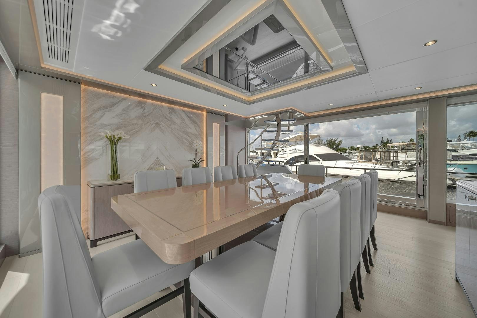 a room with a table chairs and a large window aboard CARBON COPY Yacht for Sale