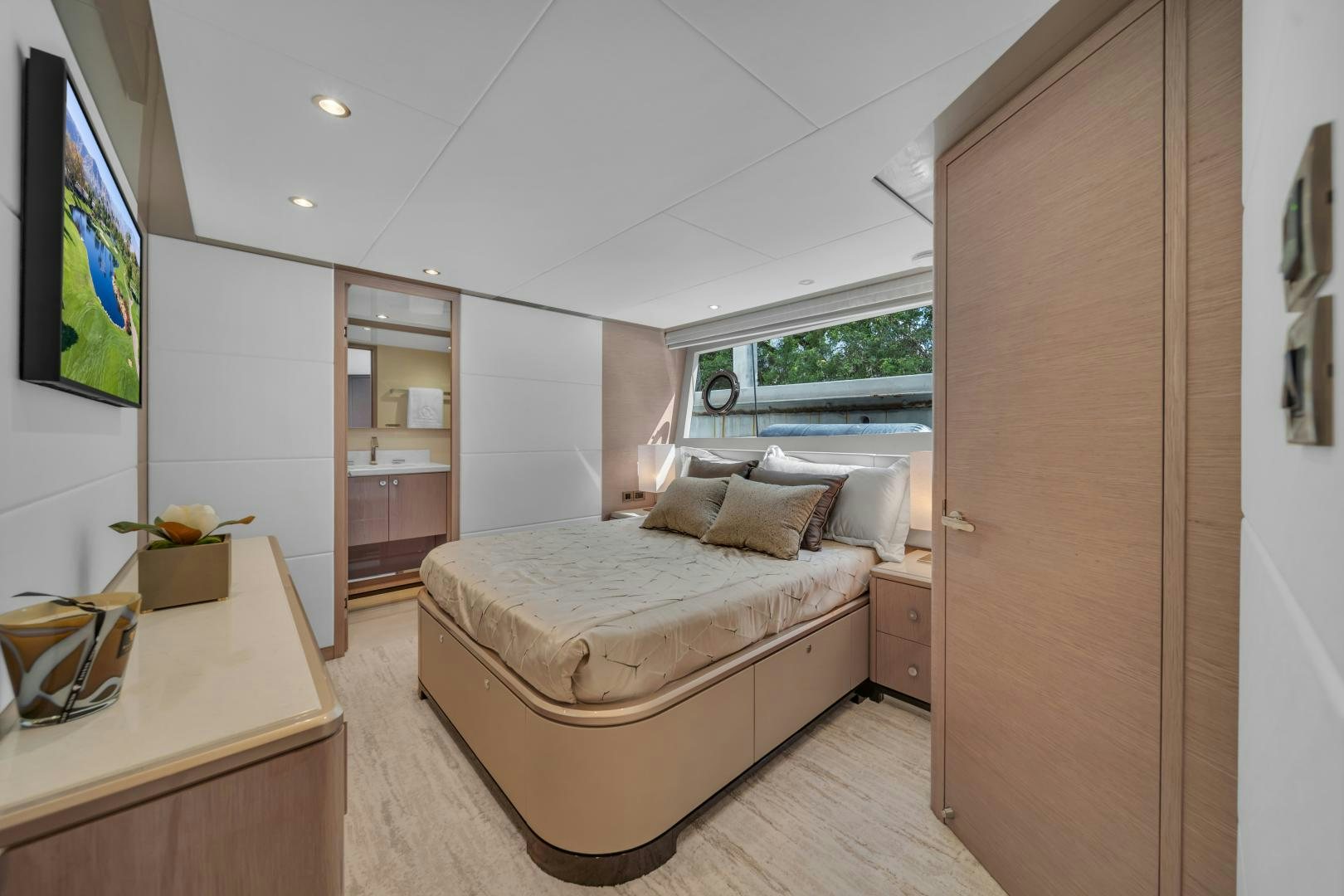 a bedroom with a bed and a tv aboard CARBON COPY Yacht for Sale