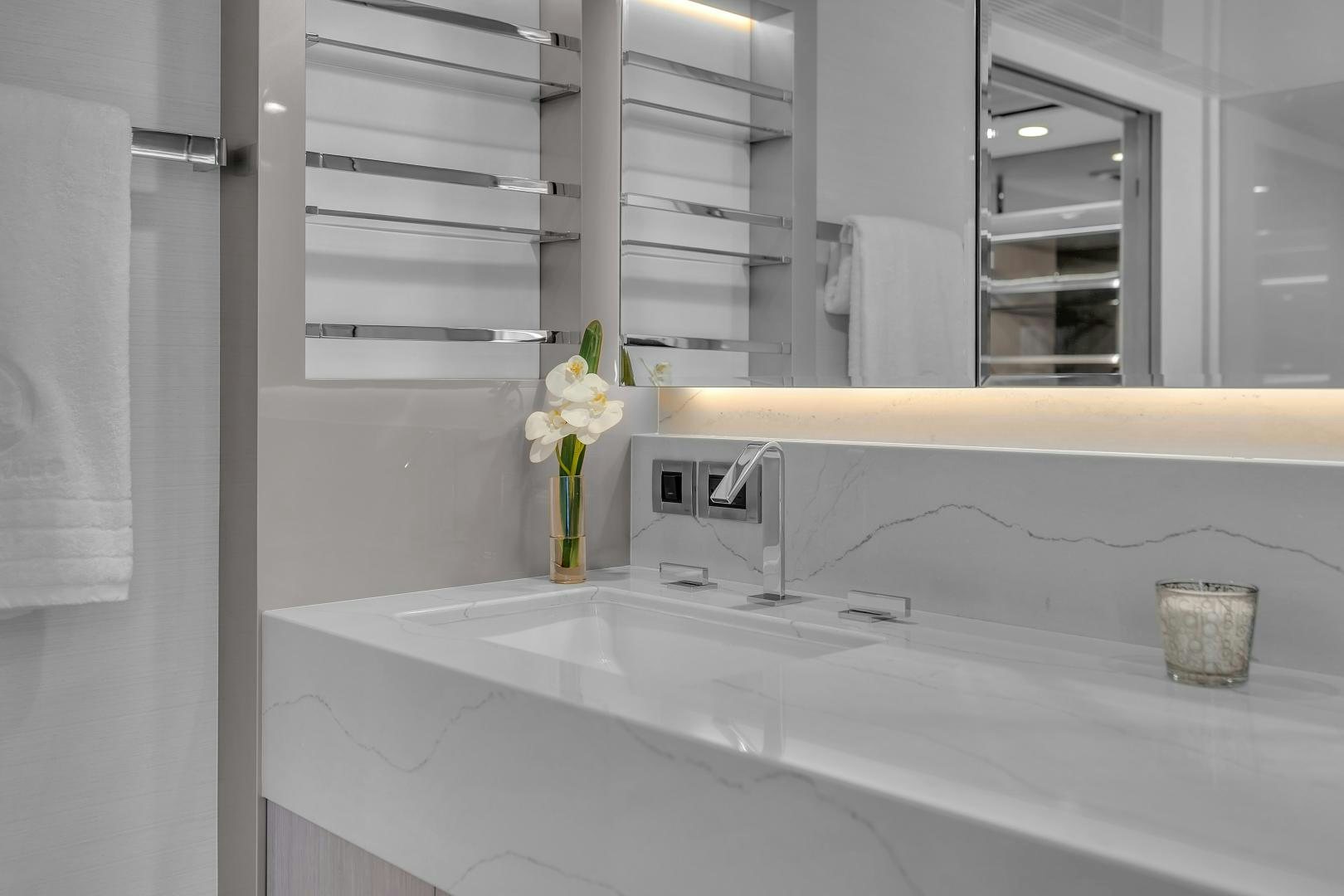 a bathroom with a flower in the sink aboard CARBON COPY Yacht for Sale