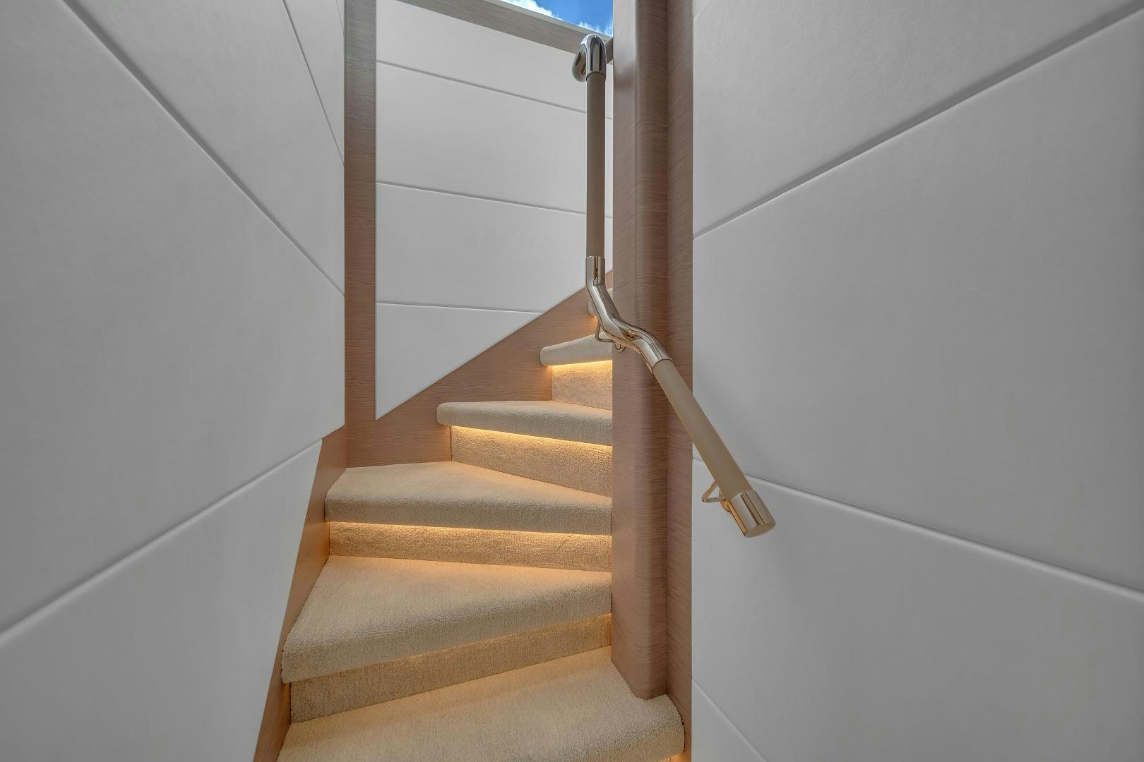 a staircase with a metal railing aboard CARBON COPY Yacht for Sale
