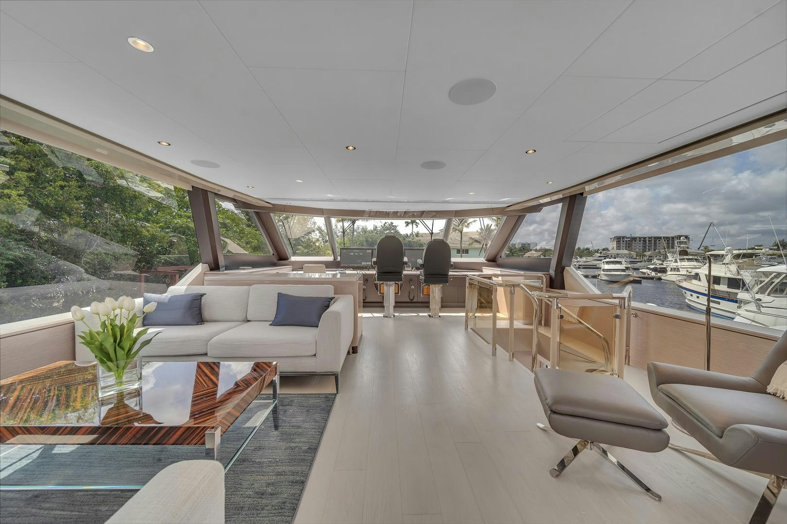 a room with a couch and a table and a view of the water aboard CARBON COPY Yacht for Sale