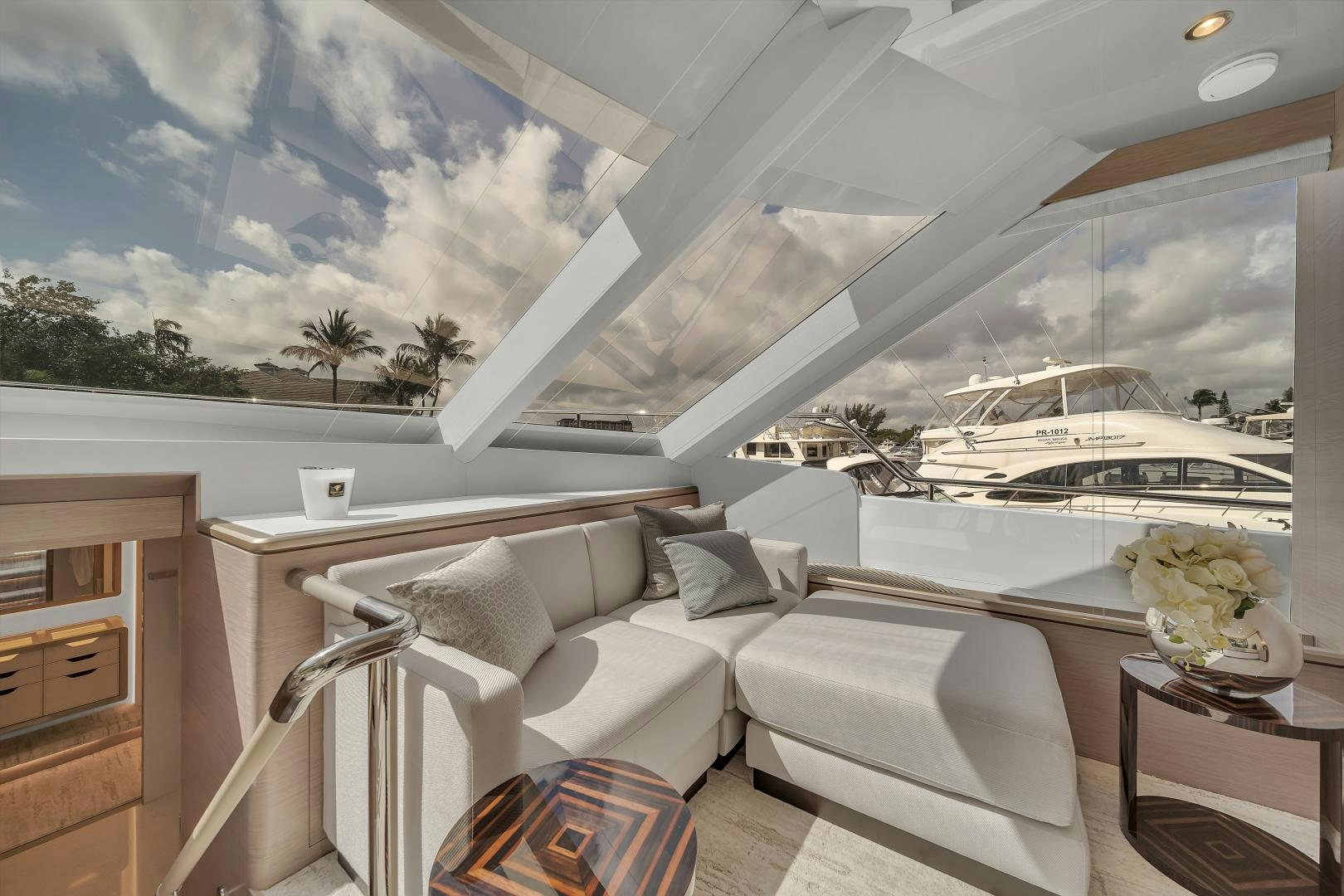 a room with a large window and a white couch and a white sofa aboard CARBON COPY Yacht for Sale