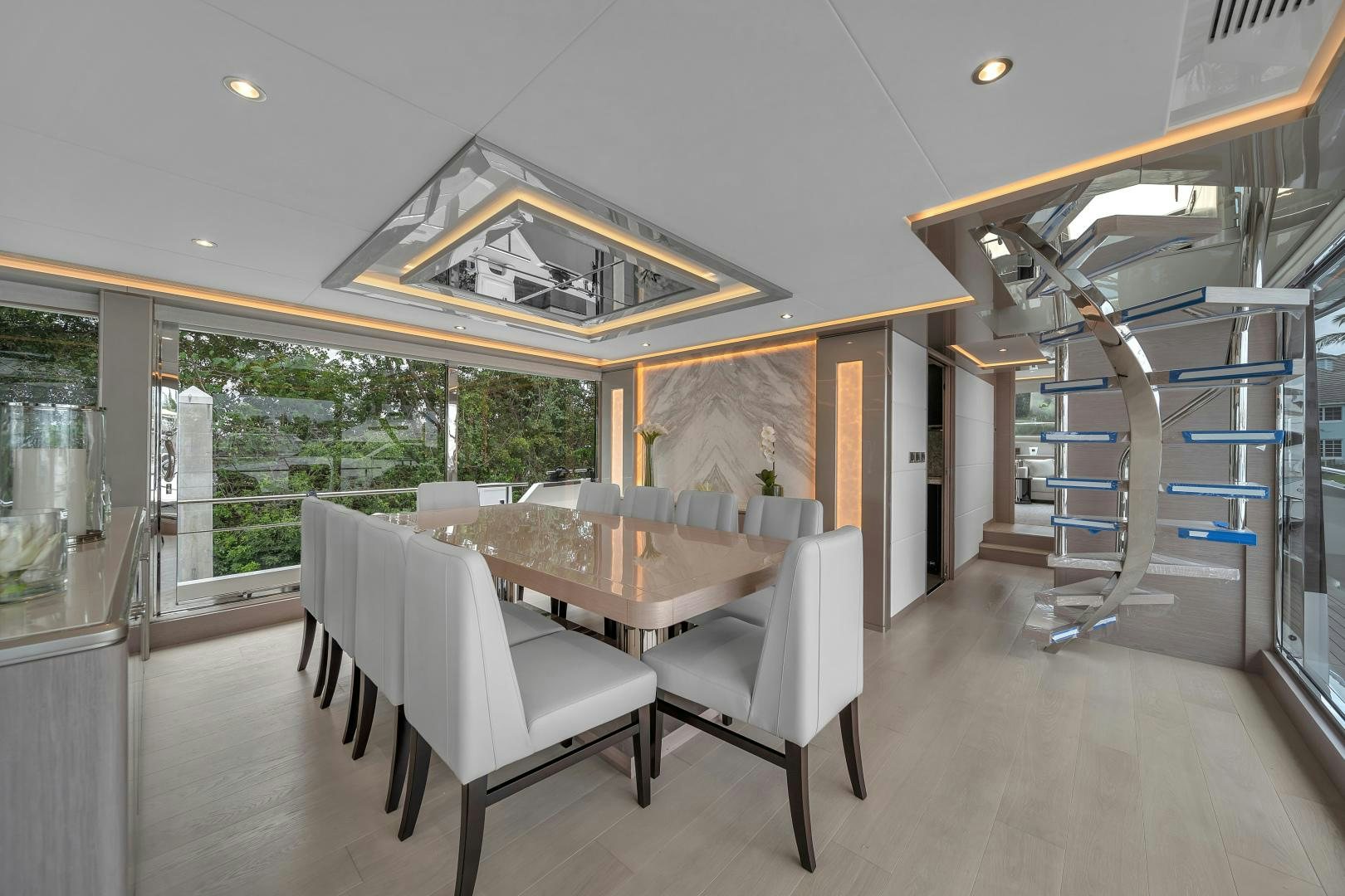 a large room with a table and chairs aboard CARBON COPY Yacht for Sale