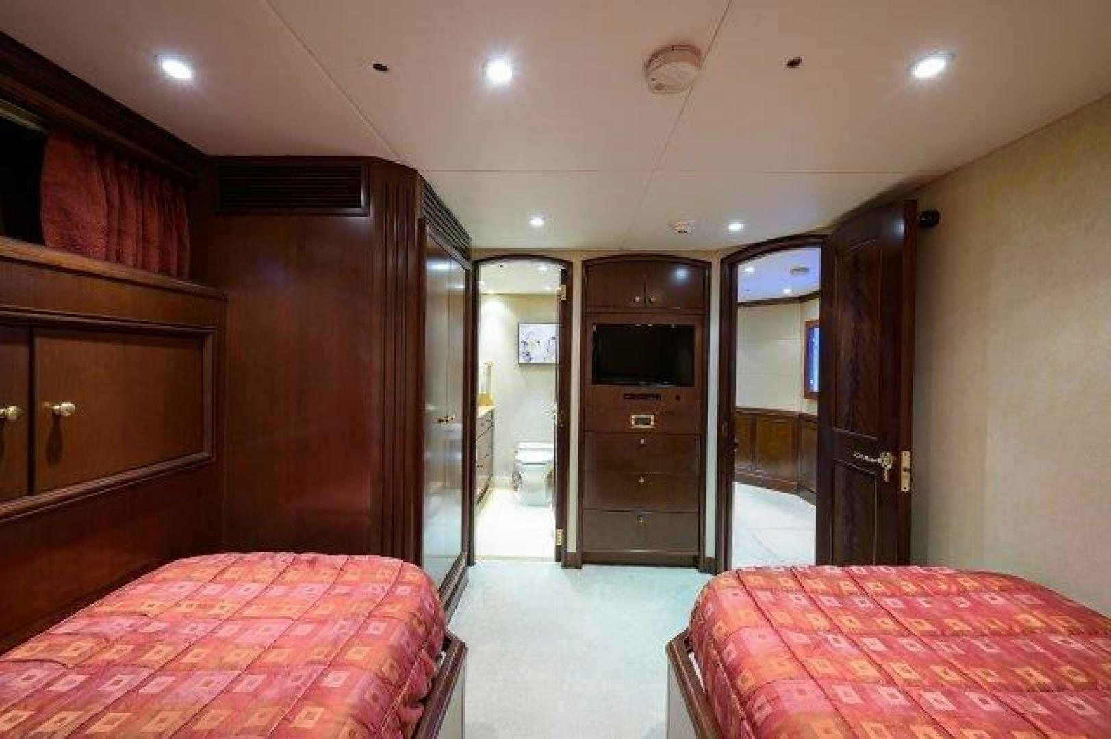 a hotel room with a bed and a tv aboard UH OH Yacht for Sale