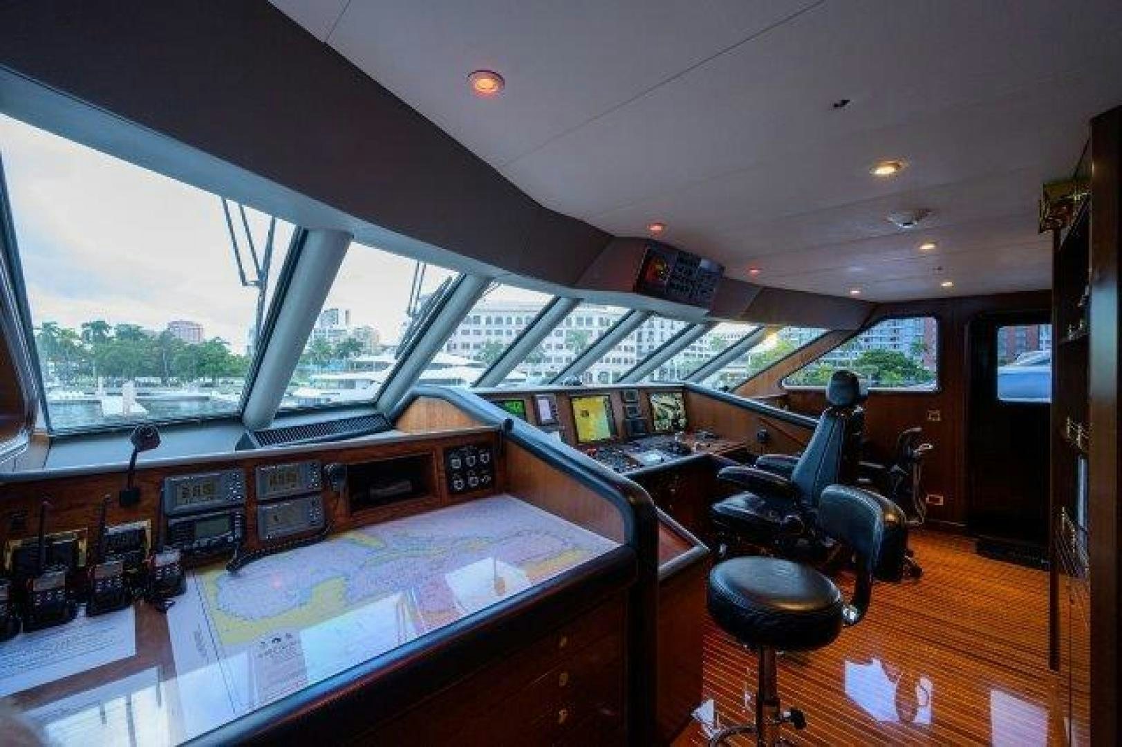 a room with a large window and a table with chairs and a large window aboard UH OH Yacht for Sale