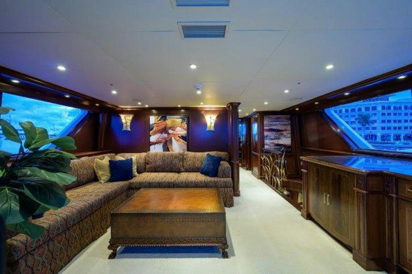 a living room with a couch and a coffee table aboard UH OH Yacht for Sale