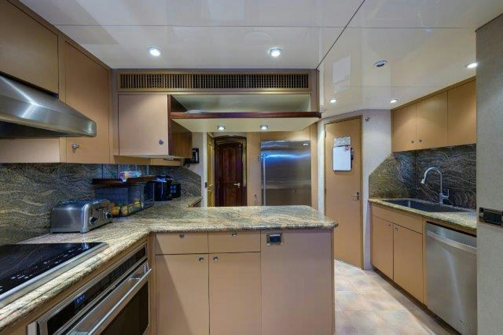 a kitchen with a sink and stove aboard UH OH Yacht for Sale